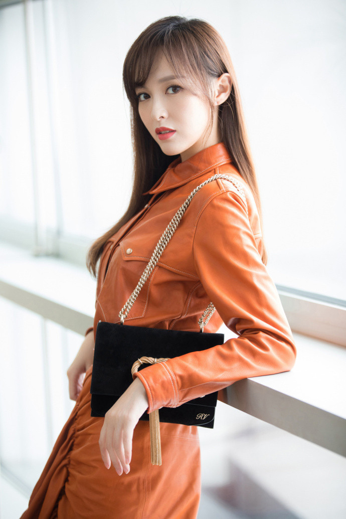 完美驾驭橘色！唐嫣身穿橘色皮质连衣裙亮相身材纤细修长回眸眼神御姐范儿十足
