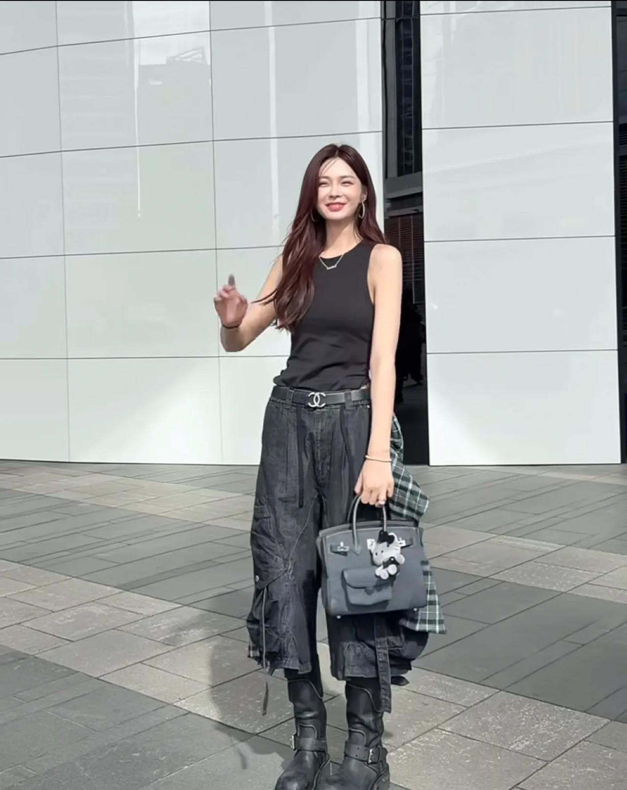 沈梦辰这组街拍氛围感直接拉满。黑色无袖背心简单利落，搭配做旧工装阔腿七分裤，腰