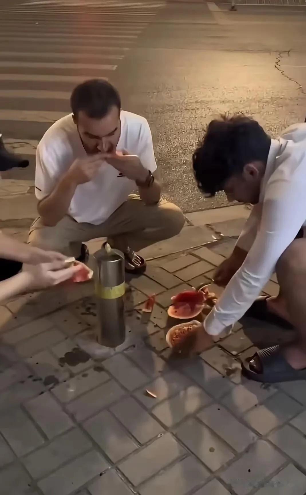 外网这段曝光视频真的看得我火冒三丈！几名外籍人员坐在国内城市人行道上吃西瓜，瓜籽