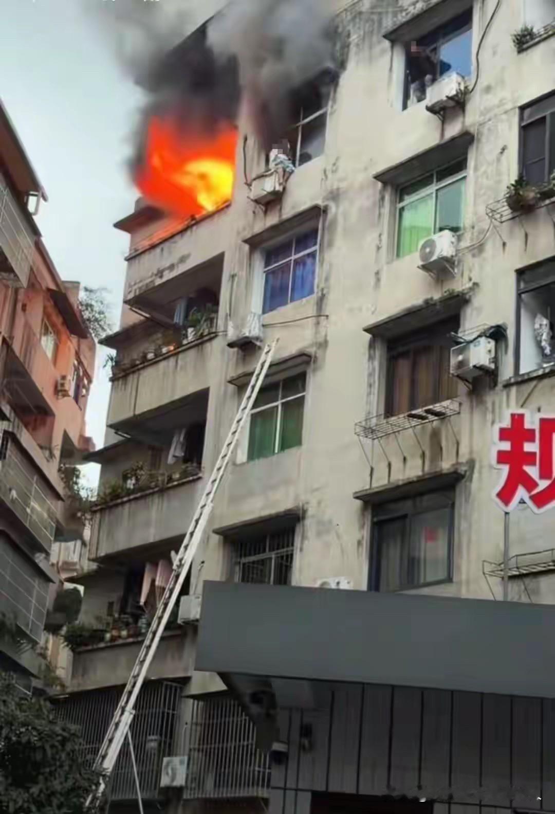 近日，四川筠连一小区，一名63岁的女子，为了躲避家里的火灾，爬到了空调外机上。