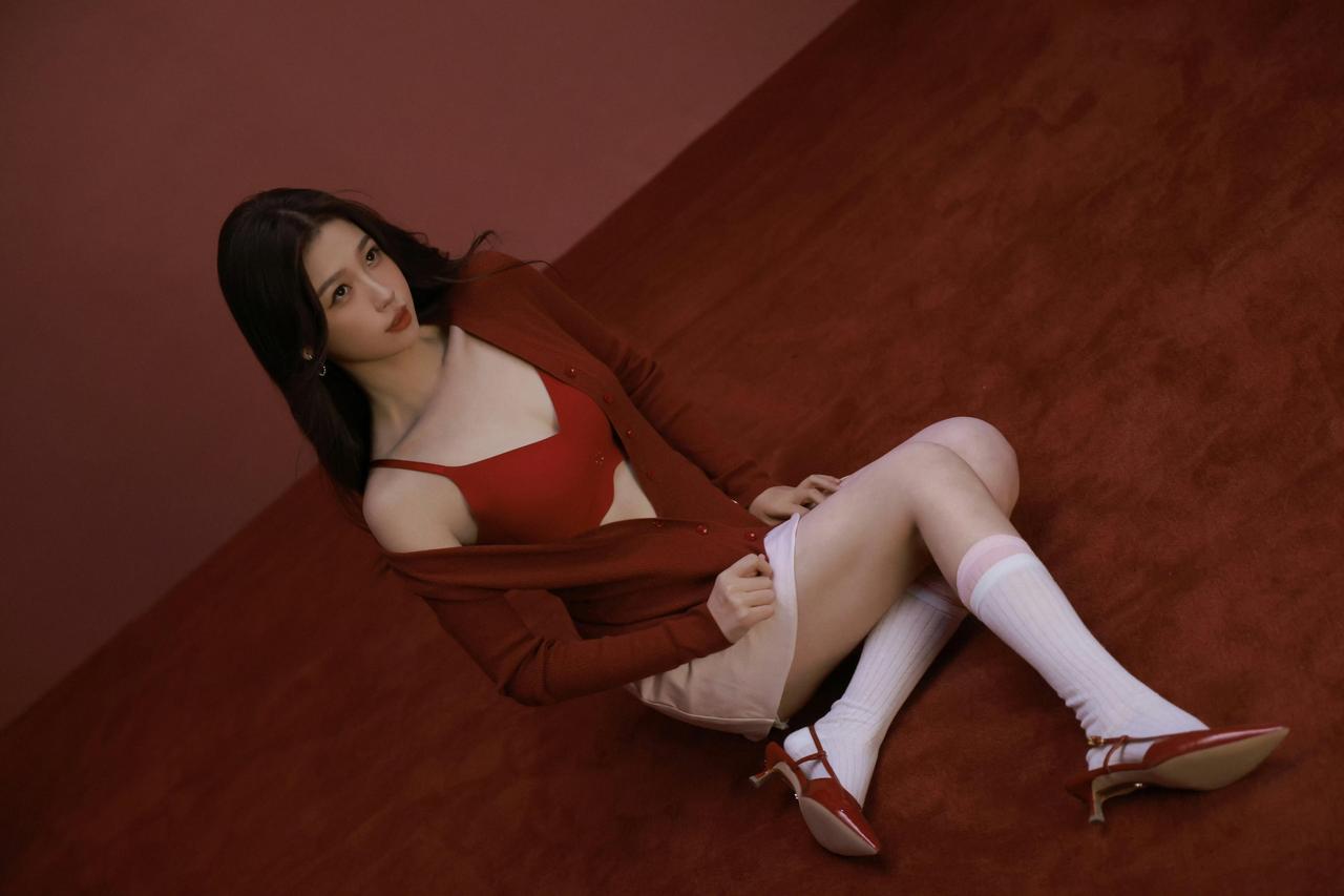 虞书欣红绒毯接住了光的碎影酒红针织衫滑过肩线像把半盏春夜披在锁骨的起伏里