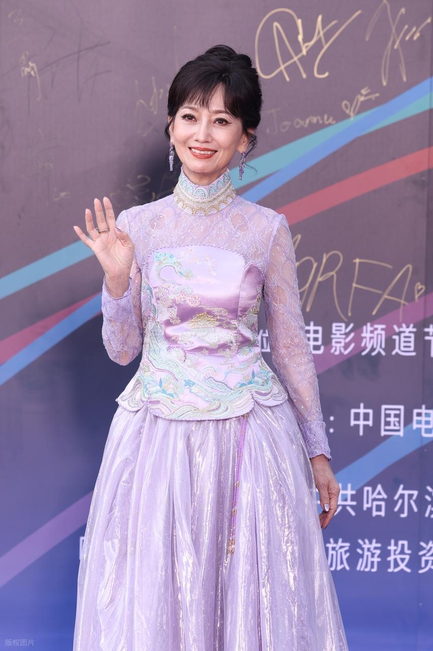 今天赵雅芝在哈尔滨走红毯，她这次搭配一件紫色的裙子，凸显出了优雅之美。赵雅芝