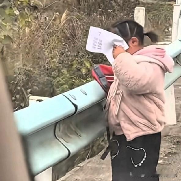 老师在返校的路上，遇到了自己的女学生，女孩用纸挡住了自己的脸，假装自己看不到老师