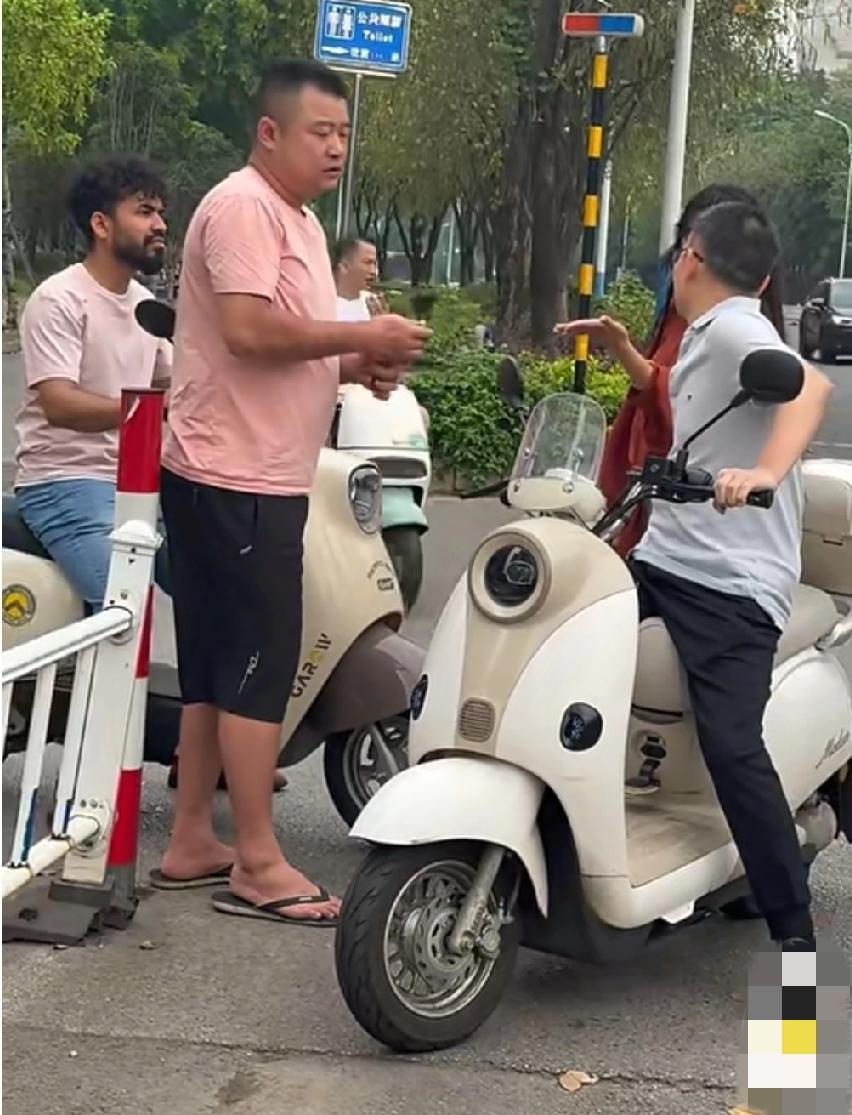 广西柳州，这名外籍男子骑车别粉衣男子，双方由此引发争执。在对峙过程中，外籍男子竟
