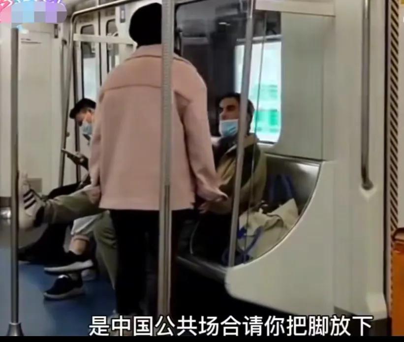外籍男子脚蹬地铁扶杆，女子气愤劝说:这是中国的公共场合！任凭女子怎么劝说，那洋人