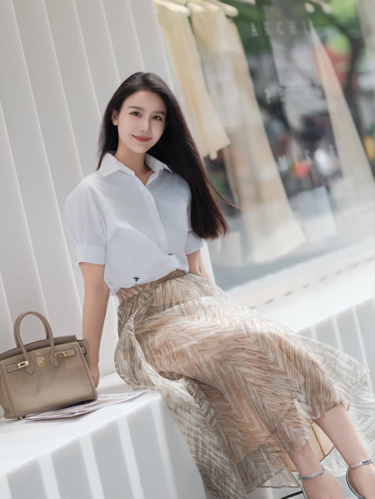 知性美女穿搭分享黑色的长发，白色的职场衬衣搭配浅咖色纱织长裙，银色的高跟凉鞋，非