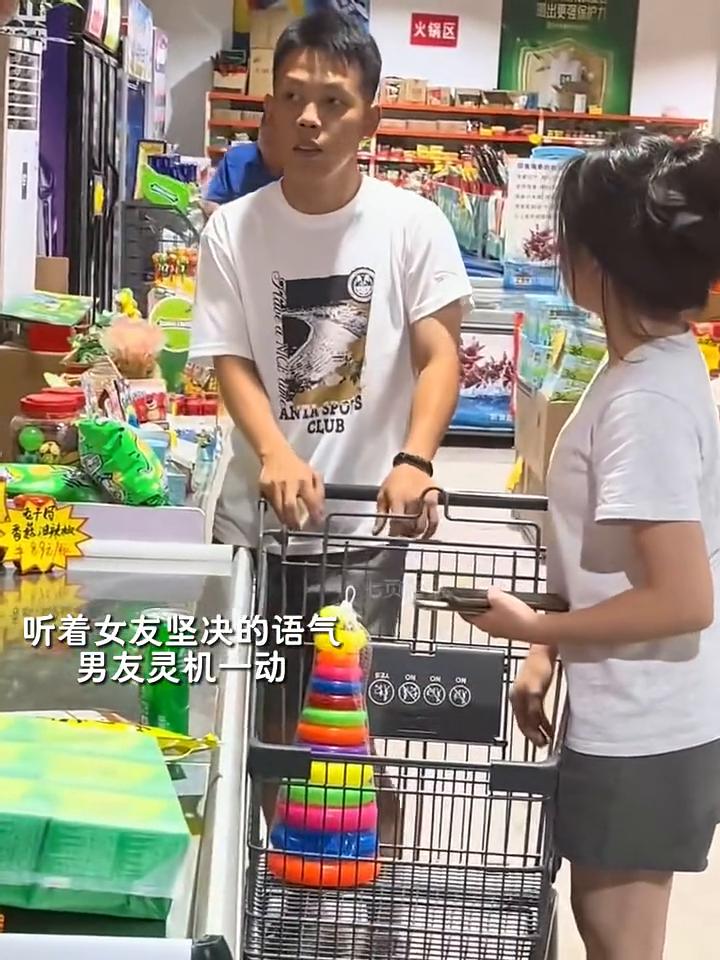 男友和女友一起逛超市，结账时女孩刚把东西拿完，男友忽然从背后掏出一个玩具，女孩却