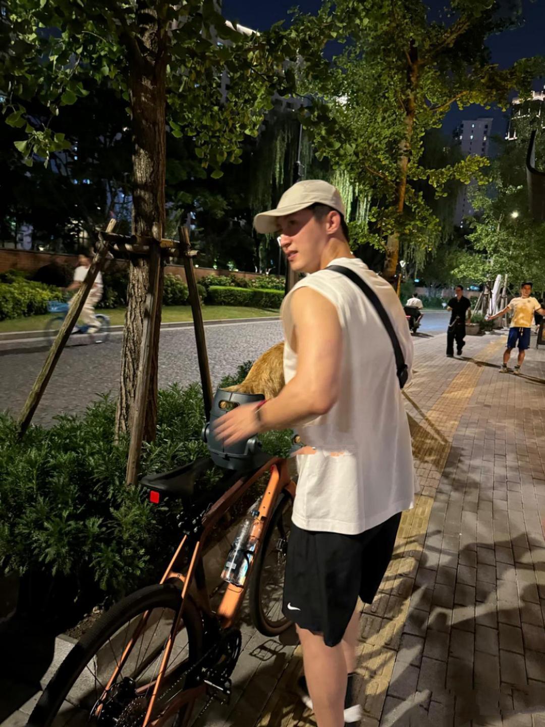 黄景瑜骑着爱车、带着爱犬在夜晚的上海街头骑行，像个阳光大男孩一样帅气。简单随意的