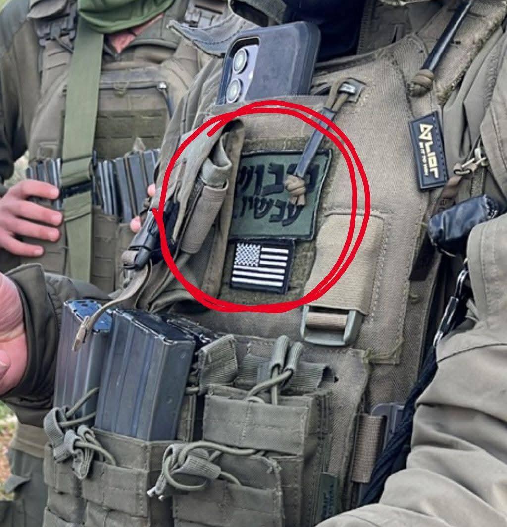 一名以色列国防军士兵在西岸希伯伦附近的一次突袭行动中，在其战术背心上佩戴着一面美