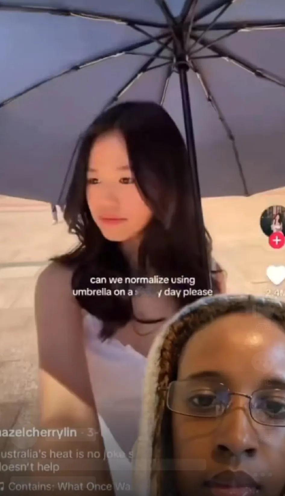 又一个闲得无事找抽的。一非洲女子看到亚洲女人为了不被晒黑而打遮阳伞，竟然又触