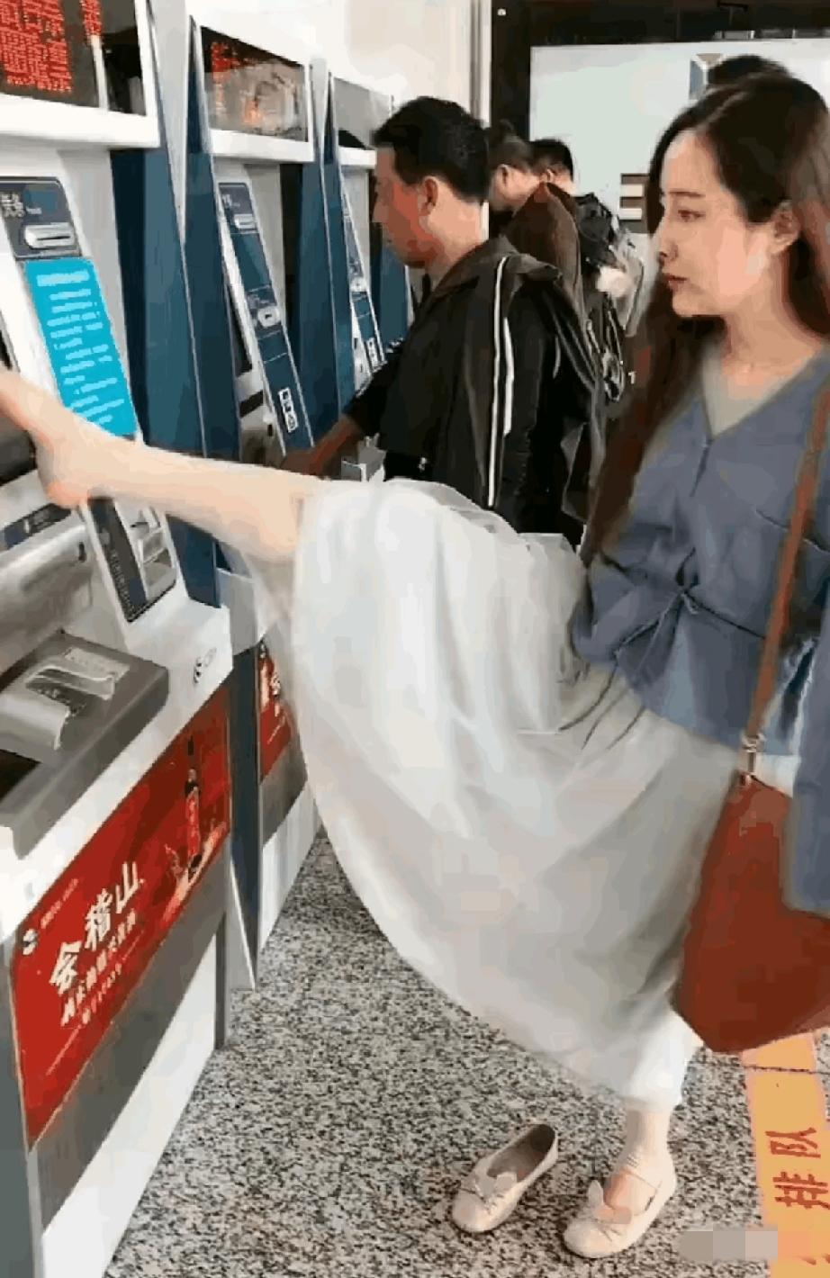 杭州地铁站，售票机前。​一个女子抬起右脚，脚趾在屏幕上快速点选，动作流畅得让人