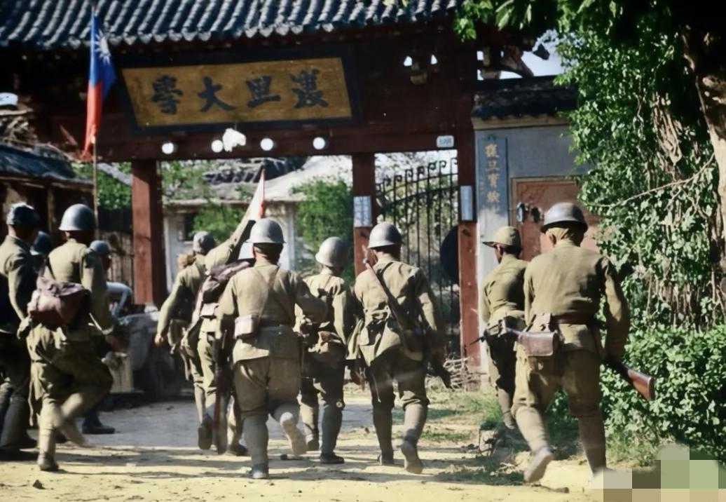 1937年淞沪会战，一群日军正冲向复旦大学江湾校区大门。1937年10月24日早