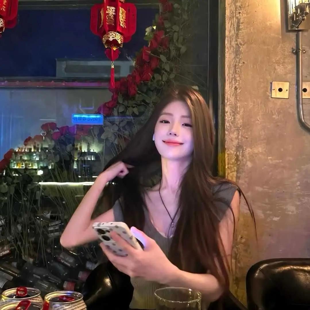 夜晚的酒吧里，微笑的少女与手机相伴，散发着温暖的光芒。御姐高跟鞋大长腿