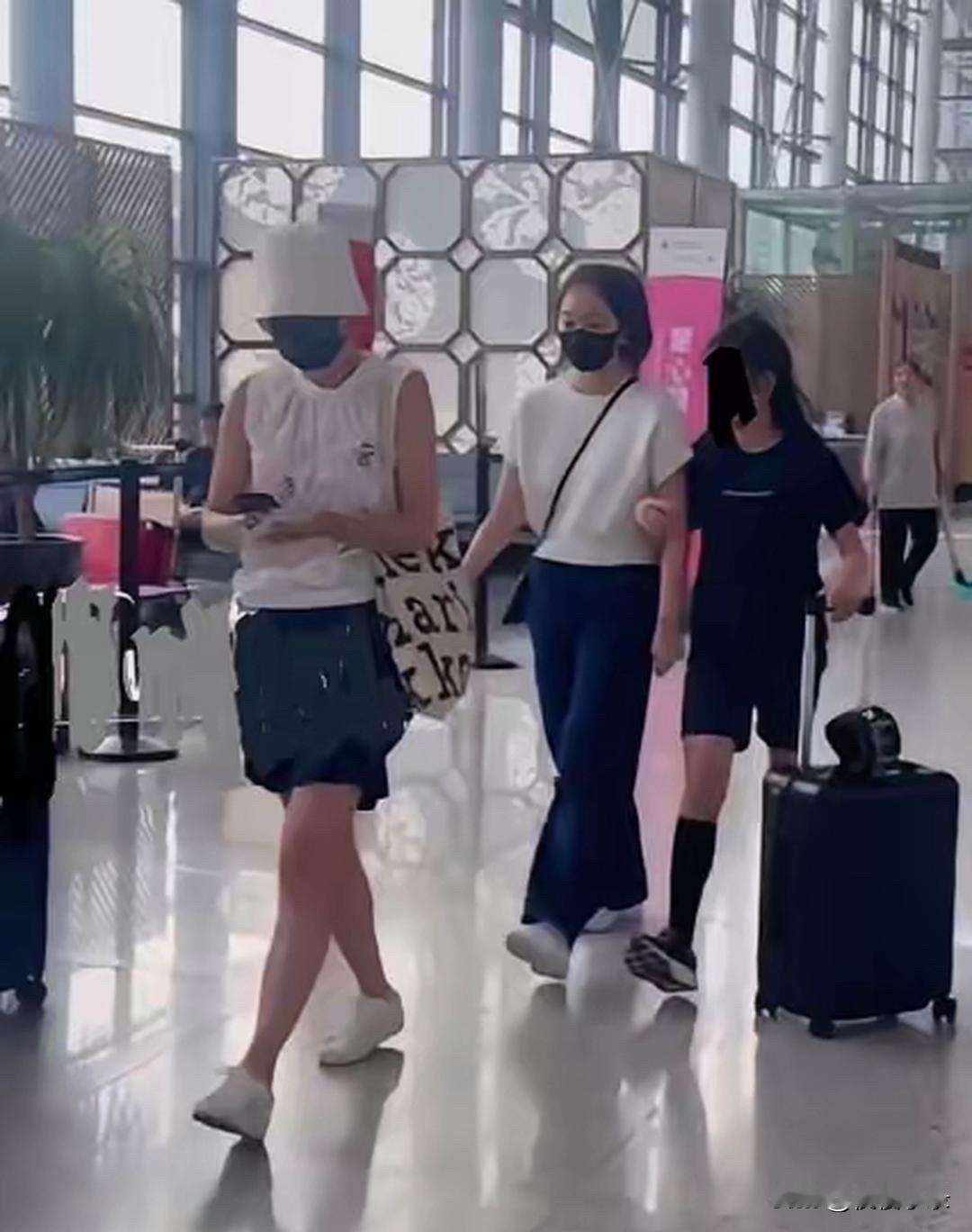 马伊琍母女三人机场露面，看样子是度假刚回来。这身穿搭特别显少女感，无袖白上衣配深