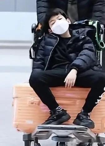 陈妍希送儿子去安徽奶奶家过年，10岁小星星穿一身黑衣，坐在行李箱上面，气质和爸爸