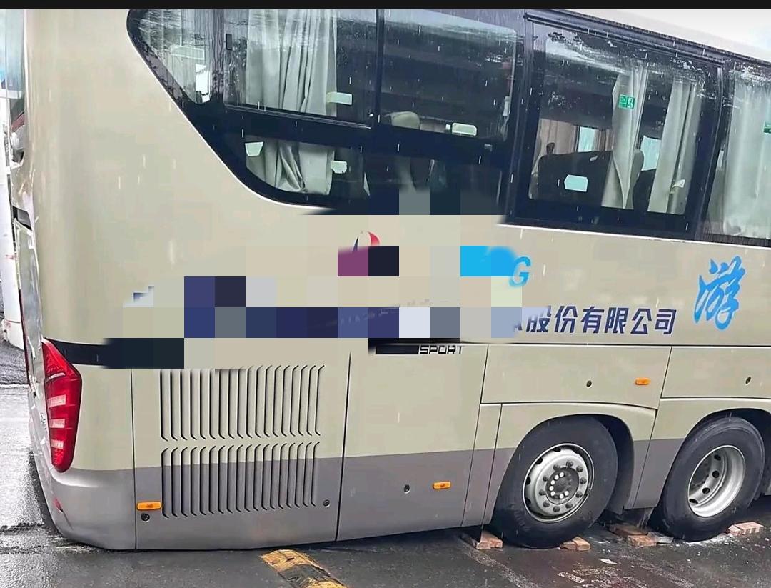 这确实是辆好车，还是能四处奔波的三轴旅行社大巴车。怪哉！如此平坦的路面，大巴车