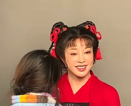 75岁演员刘晓庆现身重庆戴家巷一身中式修身装扮亮相街头，头扎朝天辫、发髻旁簪戴