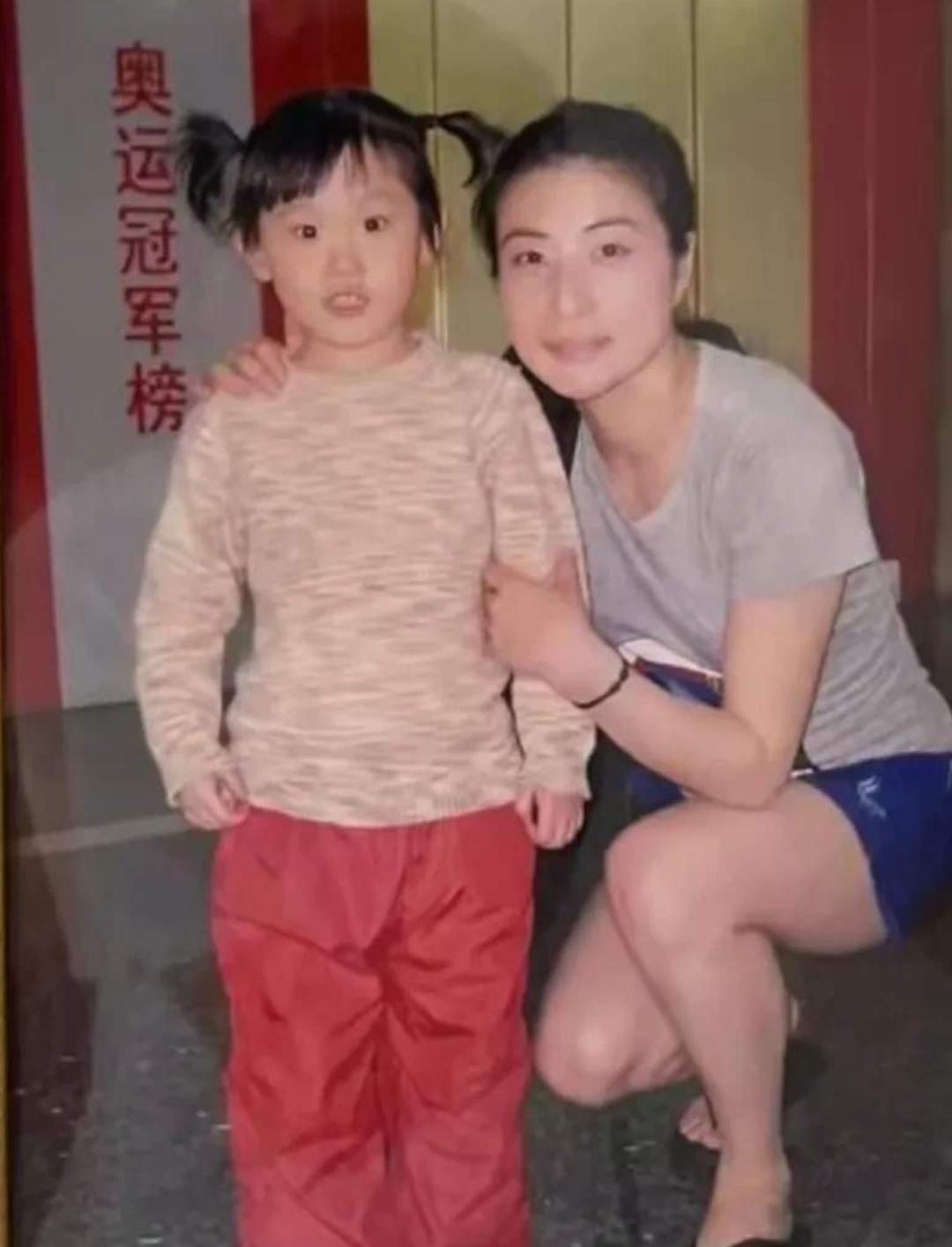 这是2009年5岁的张家齐与28岁的郭晶晶的美好合影，郭晶晶蹲下身子，轻轻地拉着