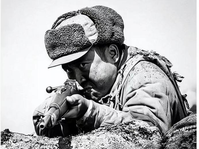 1952年，一个美国大兵嘴里叼着烟，赤条条地躺在我军阵地前晒日光浴，我军一个新兵