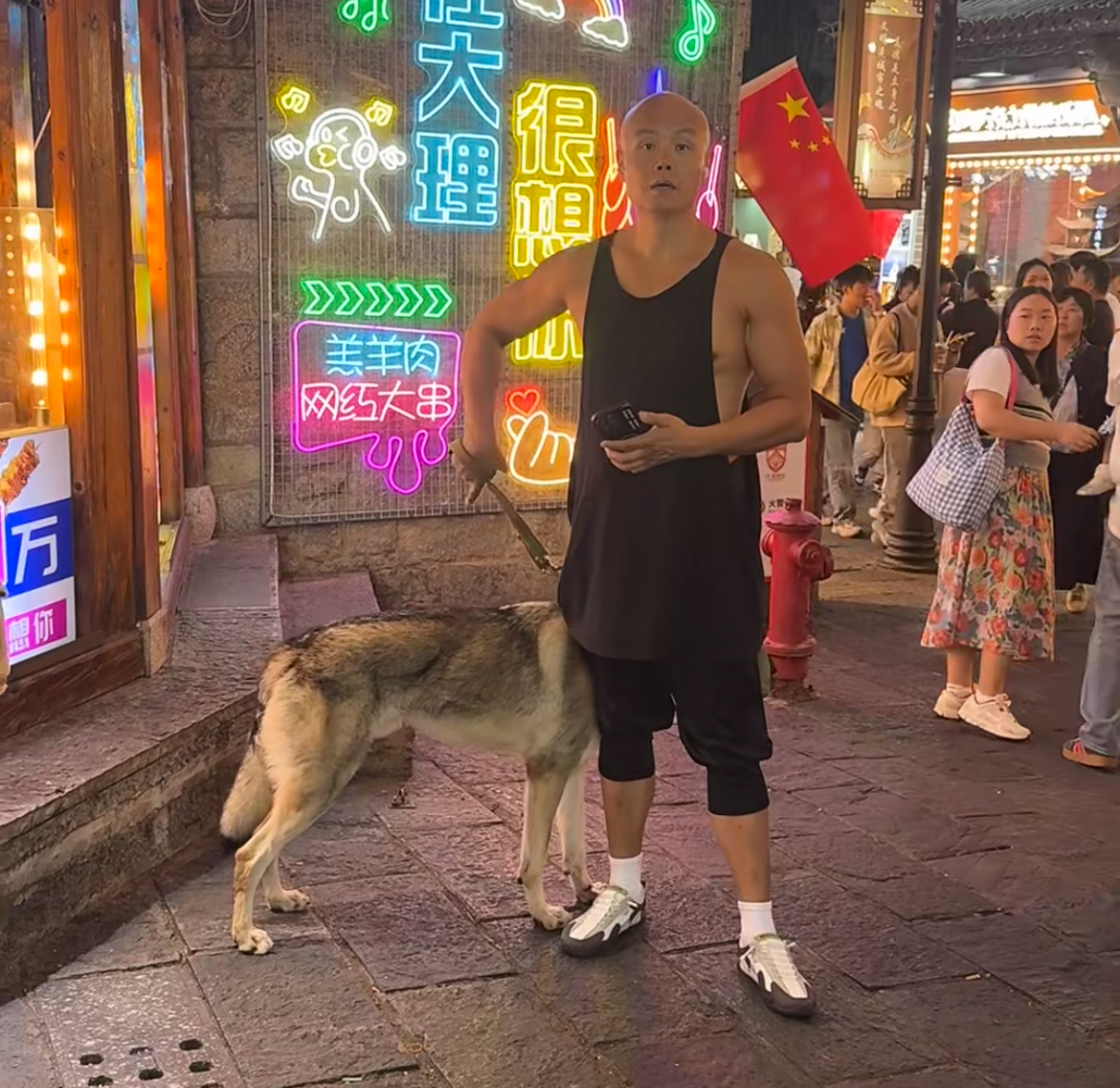 知名主持人乐嘉现身云南大理街头太不雅！手里牵着捷克狼犬，穿黑色背心满身腱子肉，