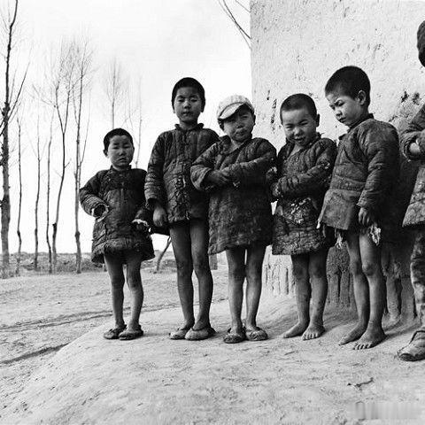 1958年甘肃省武威县（现武威市凉州区），农场里，几个刚从沙堆里御寒后爬出来玩耍