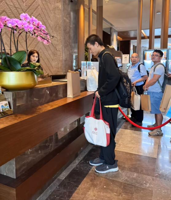 35岁韦东奕“韦神”在崇礼酒店大堂办理入住，背着大包参加数学活动，没有行李箱，拿