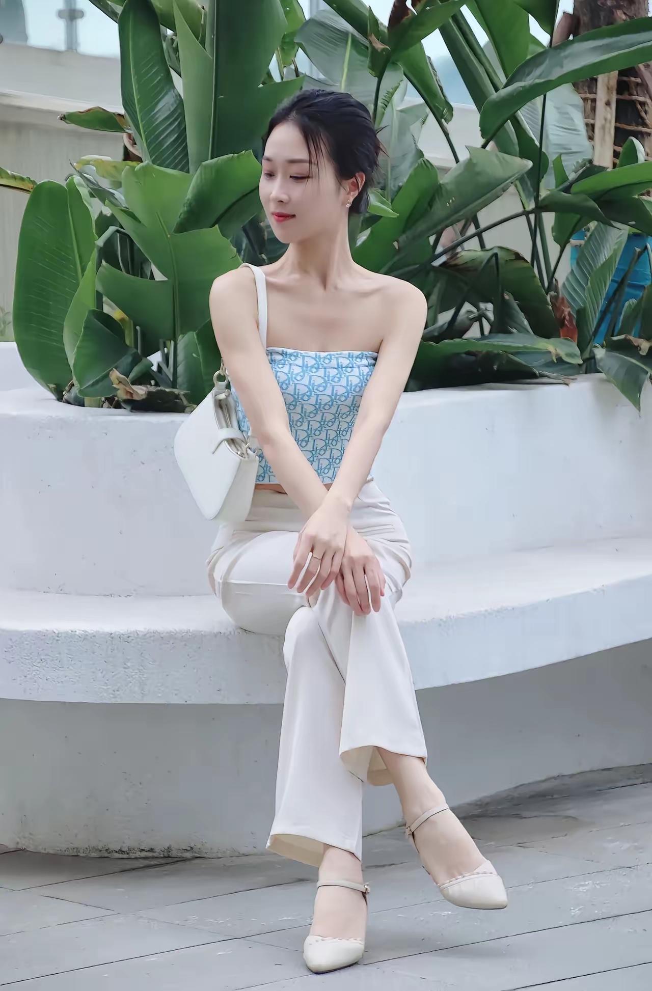 夏日清新穿搭，白色裤装搭配蓝白印花吊带，优雅坐于绿植旁。白色衬衫裙穿搭白衬衫白