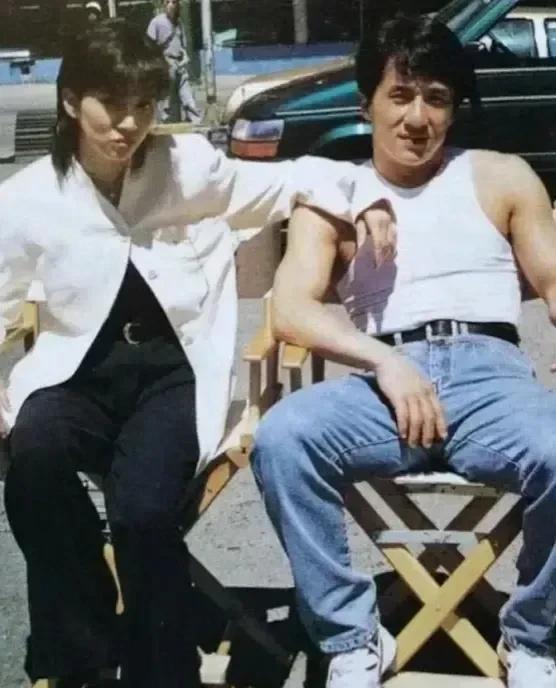 画面中的成龙乌发蓬松，浓眉星眼，身体壮实，大鼻子抢镜；一旁的美女青丝如墨，神清骨