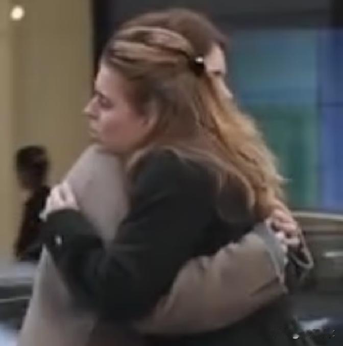 安德鲁被正式摘掉头衔那天，镜头却先给到了他的两个女儿。伦敦街头，一个拥抱、一段无