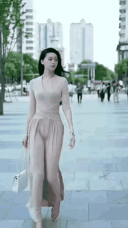 调皮的风儿肆意撩拨着翩然而至的女孩。女孩对于风儿这般“流氓”的举动，非但不反感