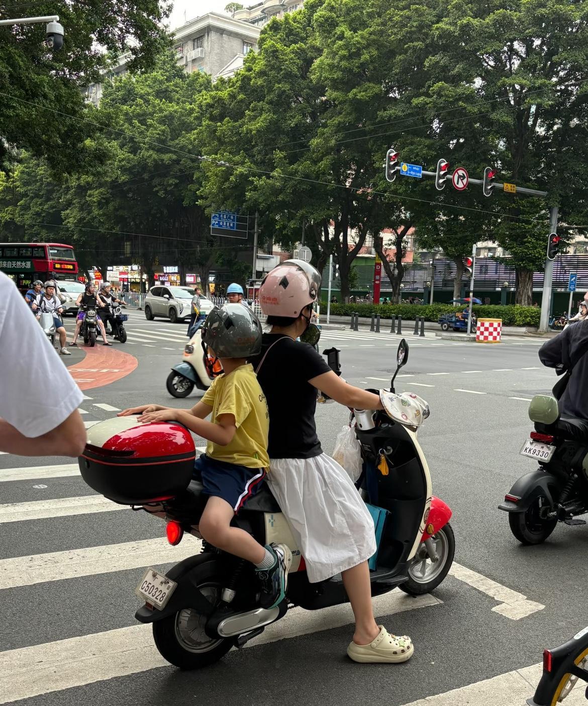 我大嫂骑电动车送自家小孩去上学，一路上严格遵守交通规则，可却被交警拦住开了罚单，