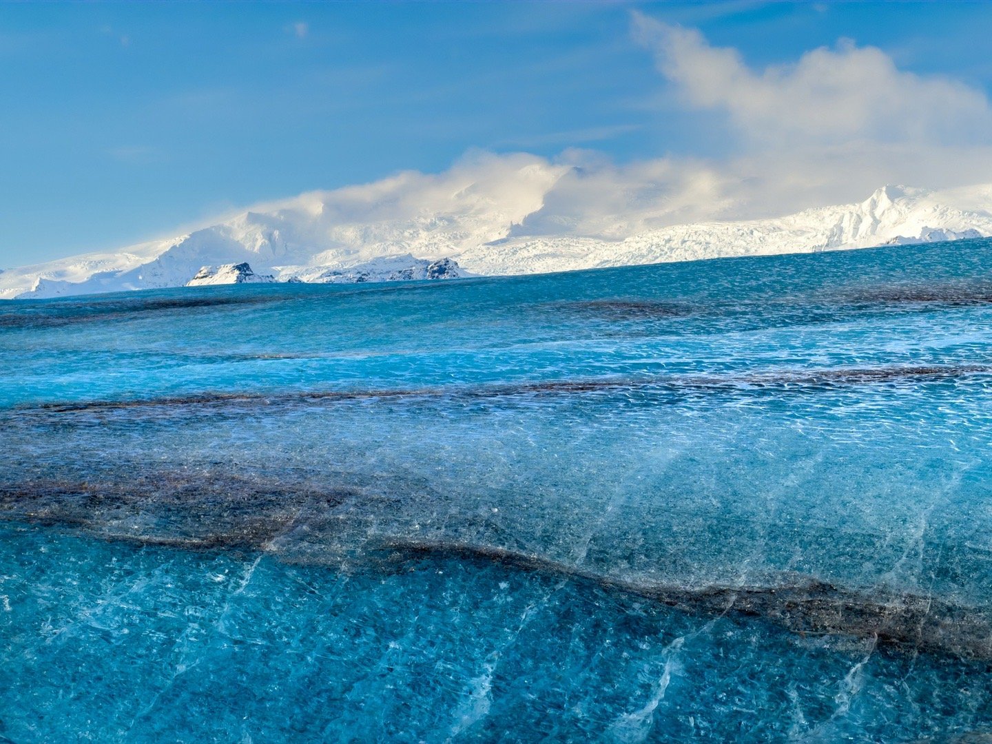 今天我们团队在瓦特纳冰川徒步，跟随专业向导深入蓝冰洞。脚下是会“呼吸”的冰河，头