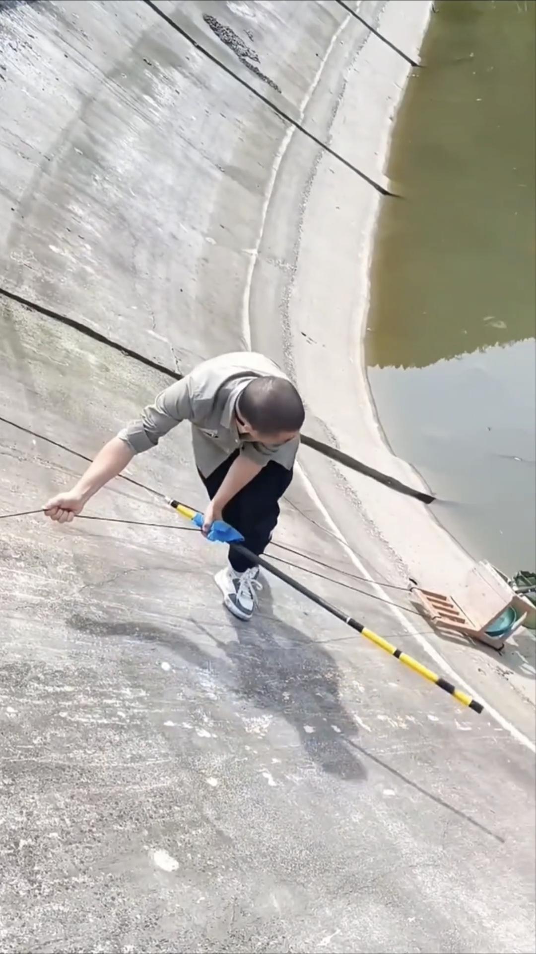 这钓个鱼也太拼了吧，至于吗？就两根绳子吊着一个板凳，倚靠在陡壁上，这里的鱼是多呀