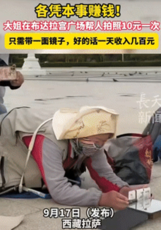 “真有做生意头脑！”西藏拉萨，一男子闲逛时，突然看到有位大姐趴在地上，帮旅客拍照
