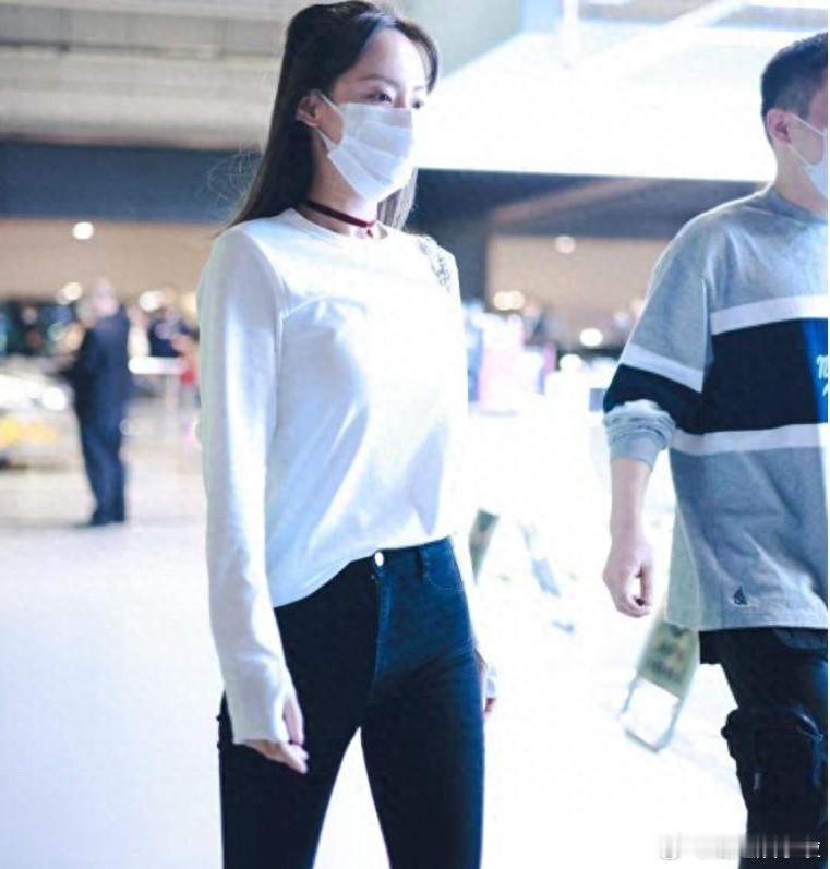 张嘉倪身着黑色紧身牛仔裤，搭配白色秋衣，尽显时尚魅力！​​​