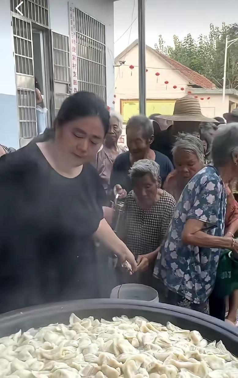这是进货来啦？社区搞公益活动，免费给老人送饺子。一位大妈提着大桶就来了。工作人员
