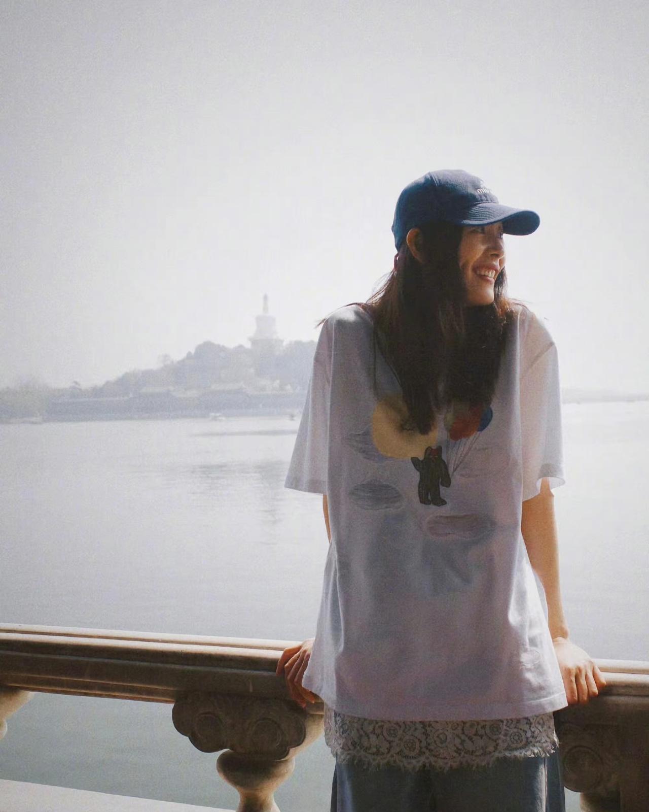 假期里，刘雯漫步于北海公园，一身简约随性的装扮格外引人注目——宽松的白色T恤搭配