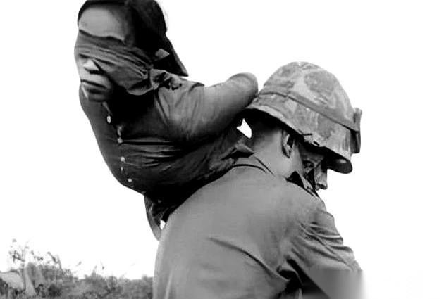 一张照片，就够了。一个美国大兵，像扛一麻袋土豆一样，把一个蒙着眼的越南女兵甩在