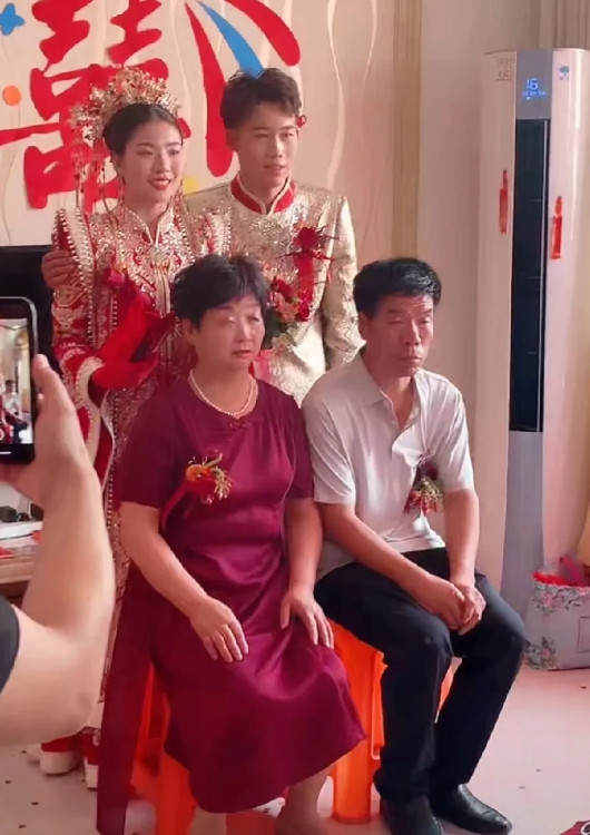聪聪啊，可算是接到他那漂亮的新娘子喽。他给新娘戴上胸花，再让新娘穿上鞋子，这就