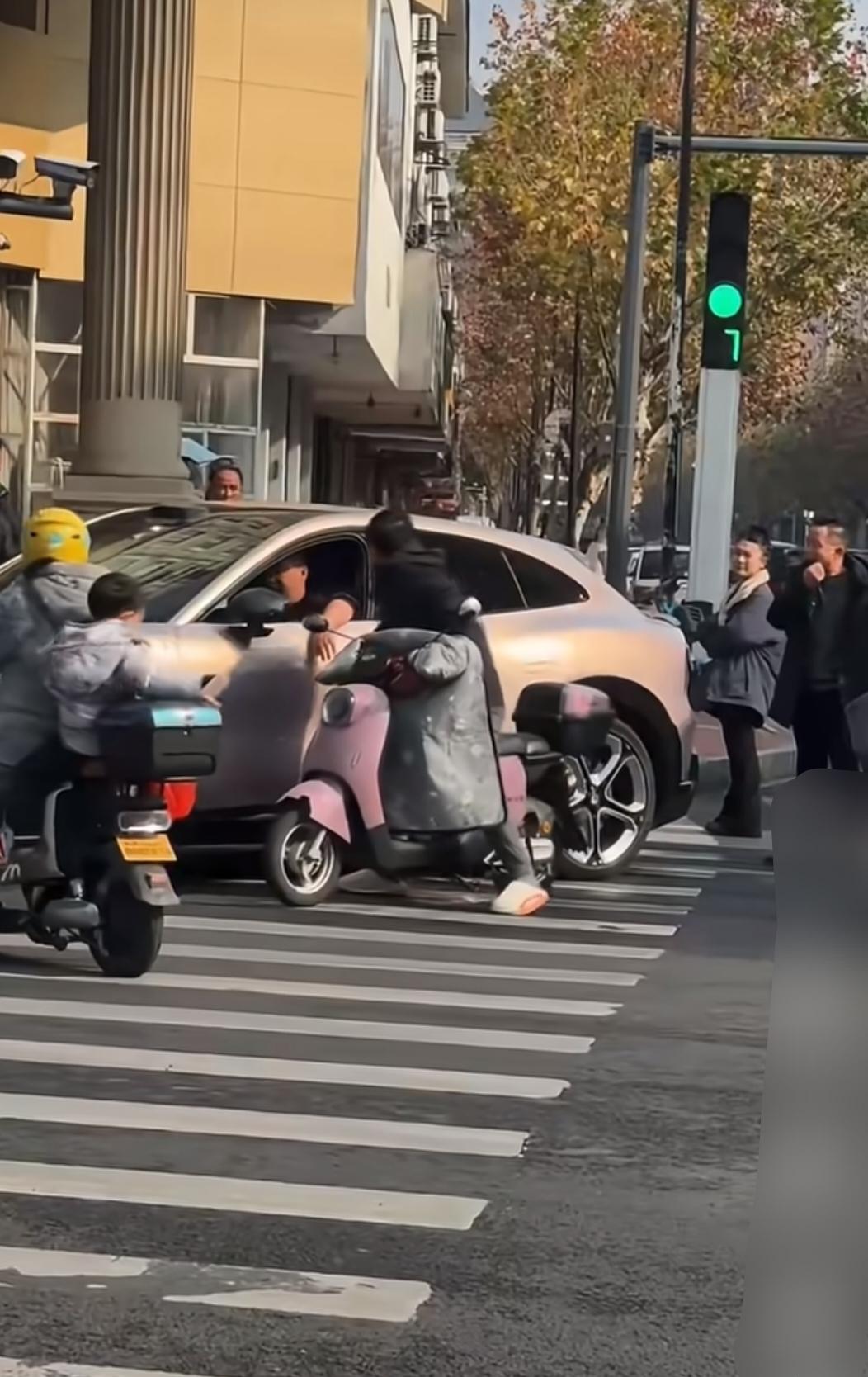 斑马线附近，小米司机跟电瓶车驾驶员发生争执，电瓶车驾驶员也是鬼的很，趁着小米司机