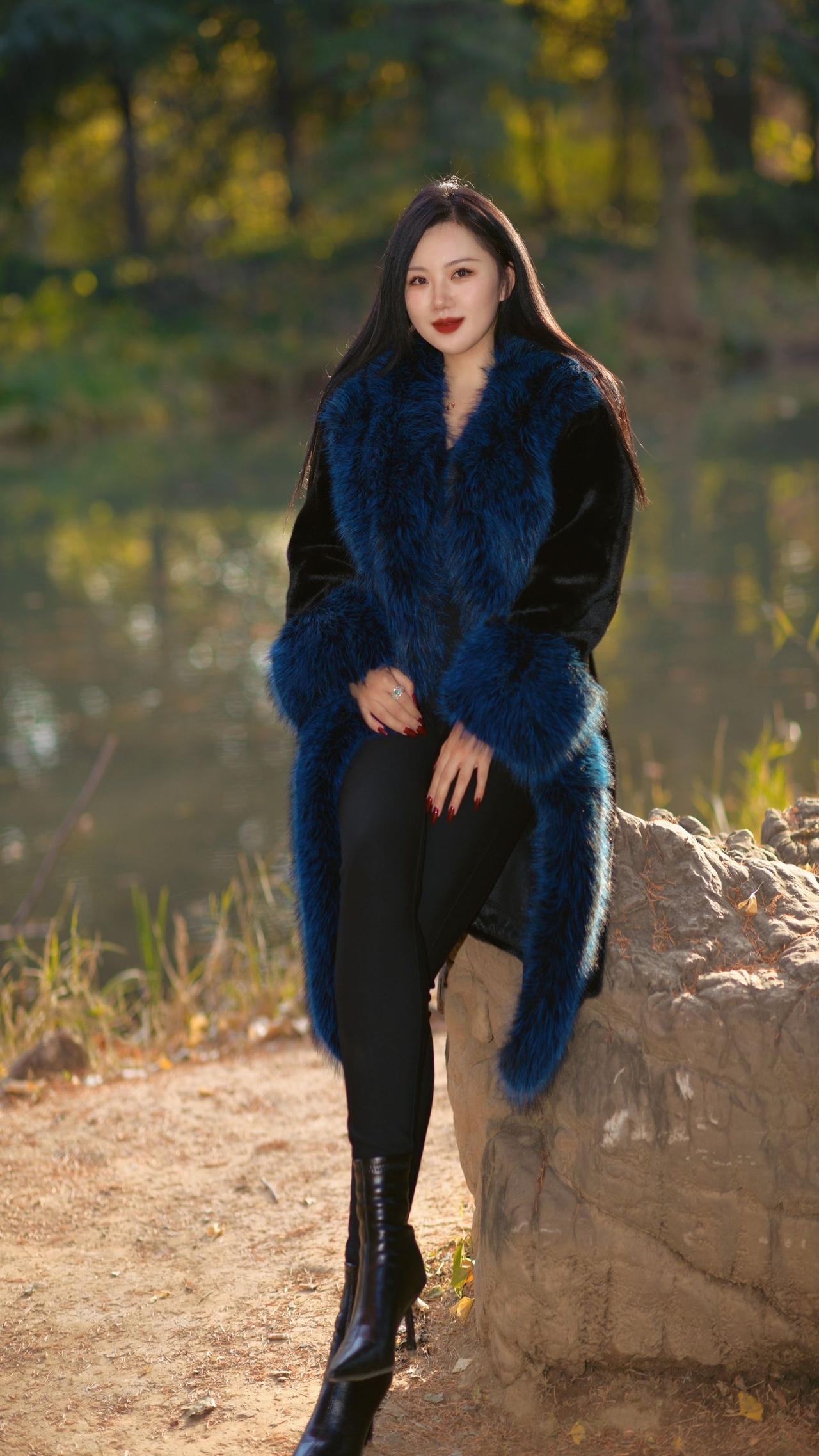 冬日暖阳下，黑裙与蓝毛外套的完美搭配，自然与时尚的完美融合。