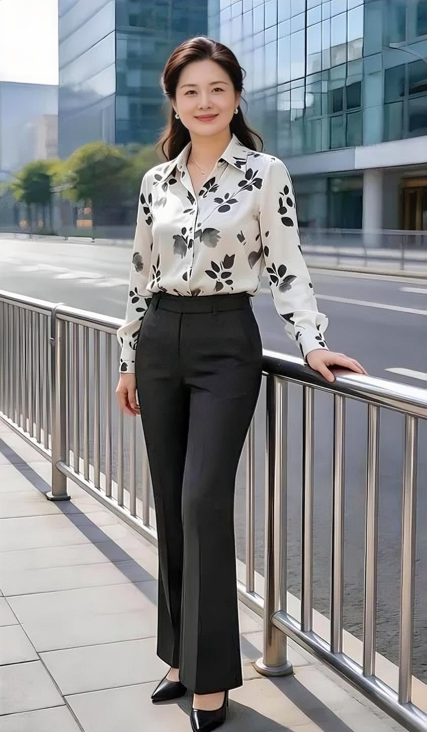 阳光正好，高楼林立，印花衬衫，搭配得体。黑裤修身，优雅自信，倚栏微笑
