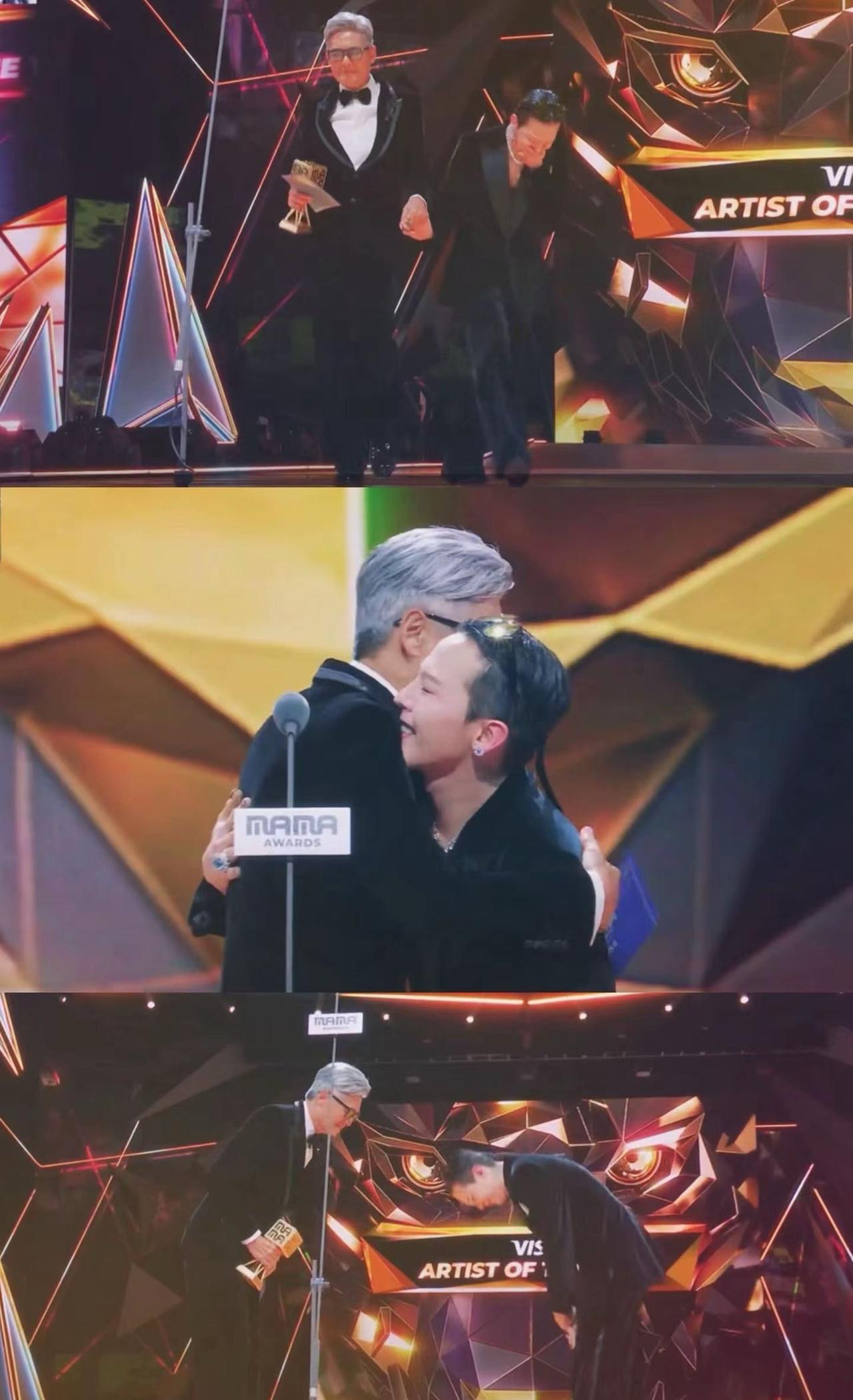 70岁的周润发牵着权志龙走上颁奖台时，台下响起经久不息的掌声。这一刻，仿