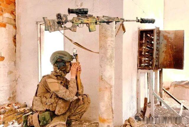 俄军狙击手使用潜望镜观察，SVD精确射手步枪放在架子上。