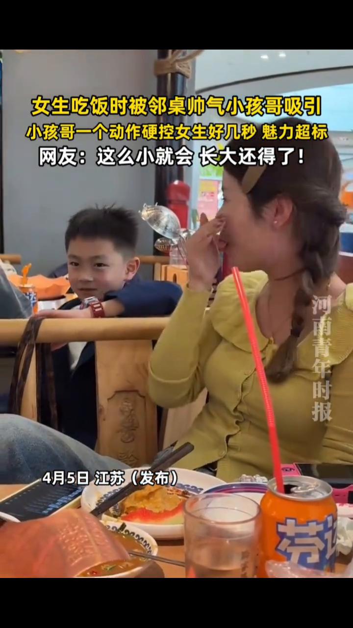女生吃饭时被邻桌帅气小孩哥吸引，小孩哥一个动作硬控女生好几秒，魅力超标。河南青