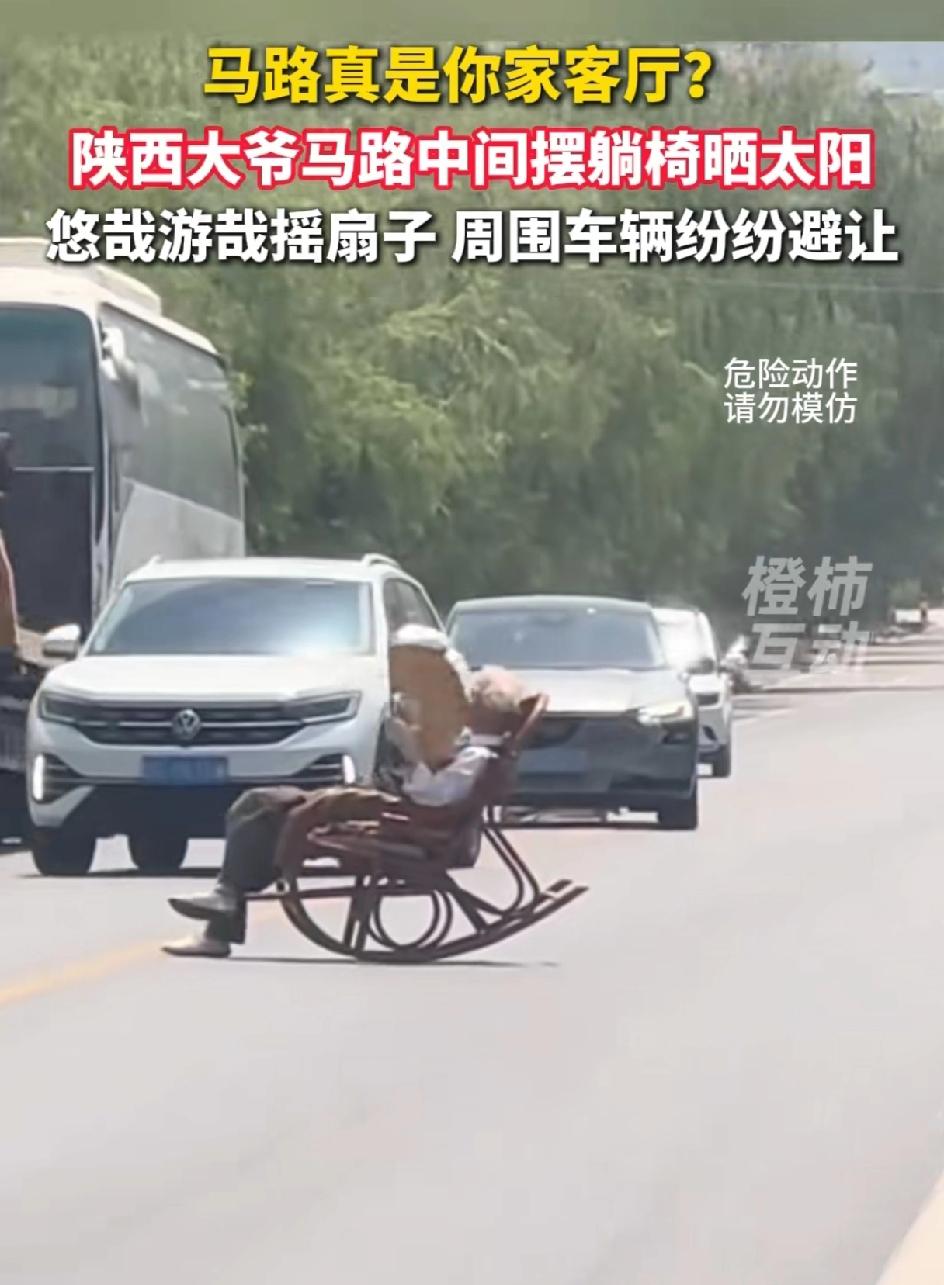 大爷的操作真的是绝了，拿一把躺椅躺在马路中间晒太阳。马路真的成了你家客厅了？他还