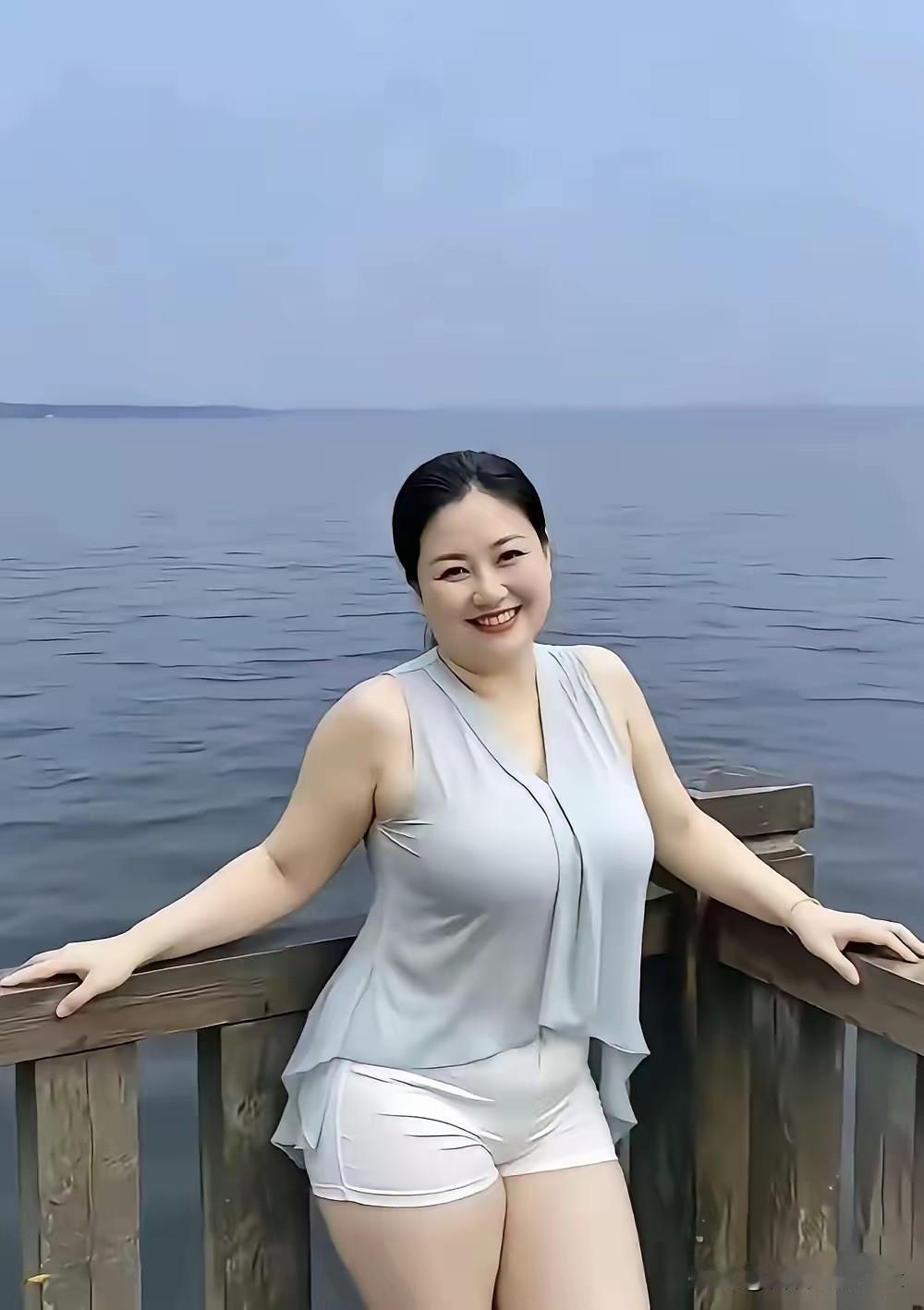 定风波·湖畔怡情浩渺平湖映远天，凭栏一笑自安然。淡色衣衫随风软，舒缓，浮