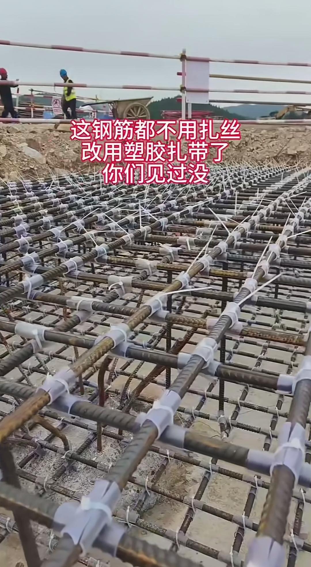 钢筋上套着白色隔离套件，这种绑扎工艺着实让人好奇！钢筋绑扎的现场里，钢筋交叉位