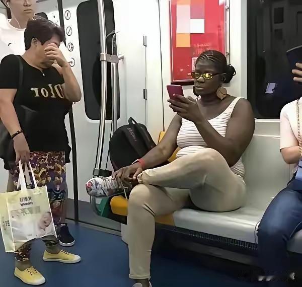 一人占两个座位，行李包包放在座位上不妥吧？地铁上，这女人把包包放在座位上，一