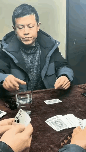 有谁能猜出来这个男人手里拿的牌到底是什么牌呢？虽然这个男人表面上故作镇定，但是看